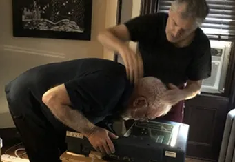 Kurt Novak adjusting the scanner bed with an assistant